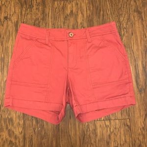 Coral colored cargo shorts.